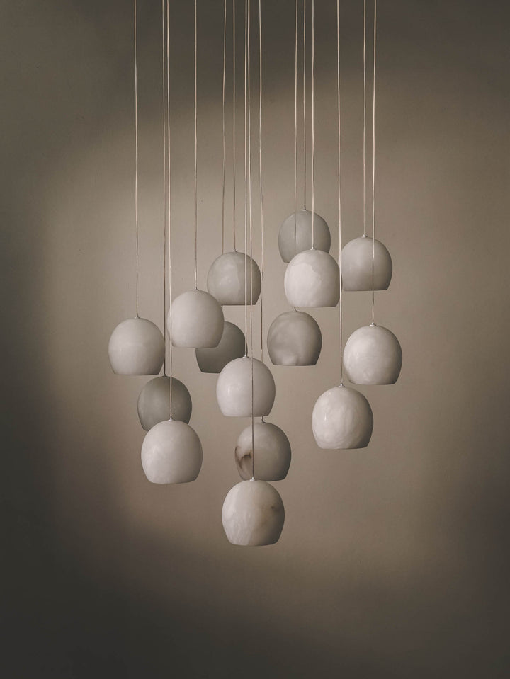 15-bulb multi pendant with alabaster shade and stainless-steel frame.