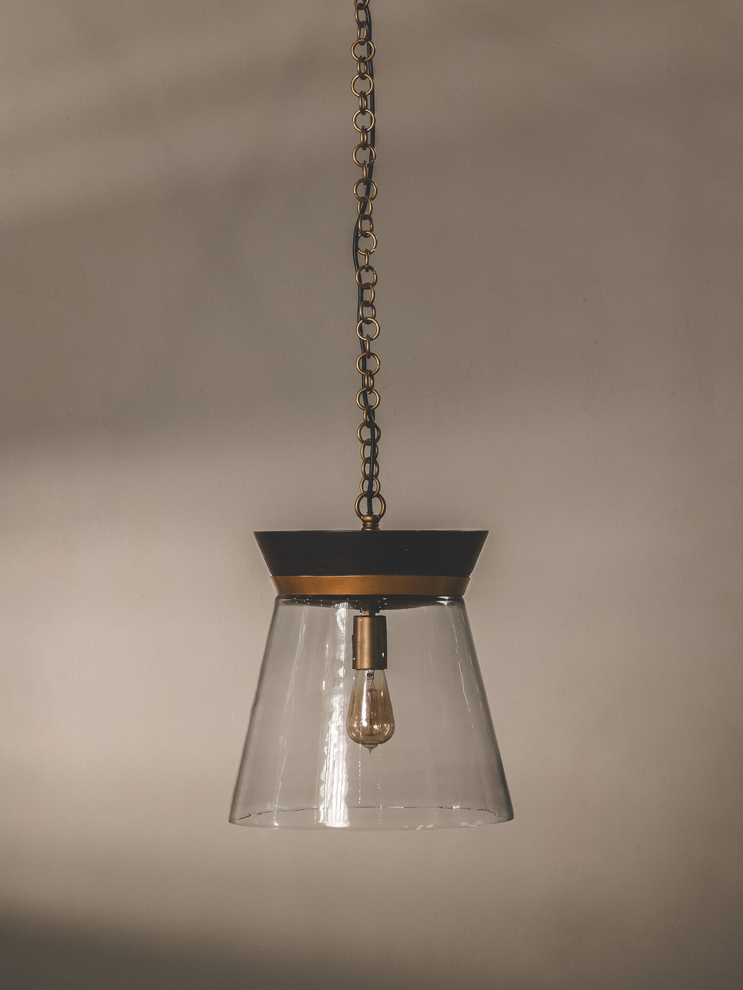Clear-glass pendant with mango wood detail and steel support