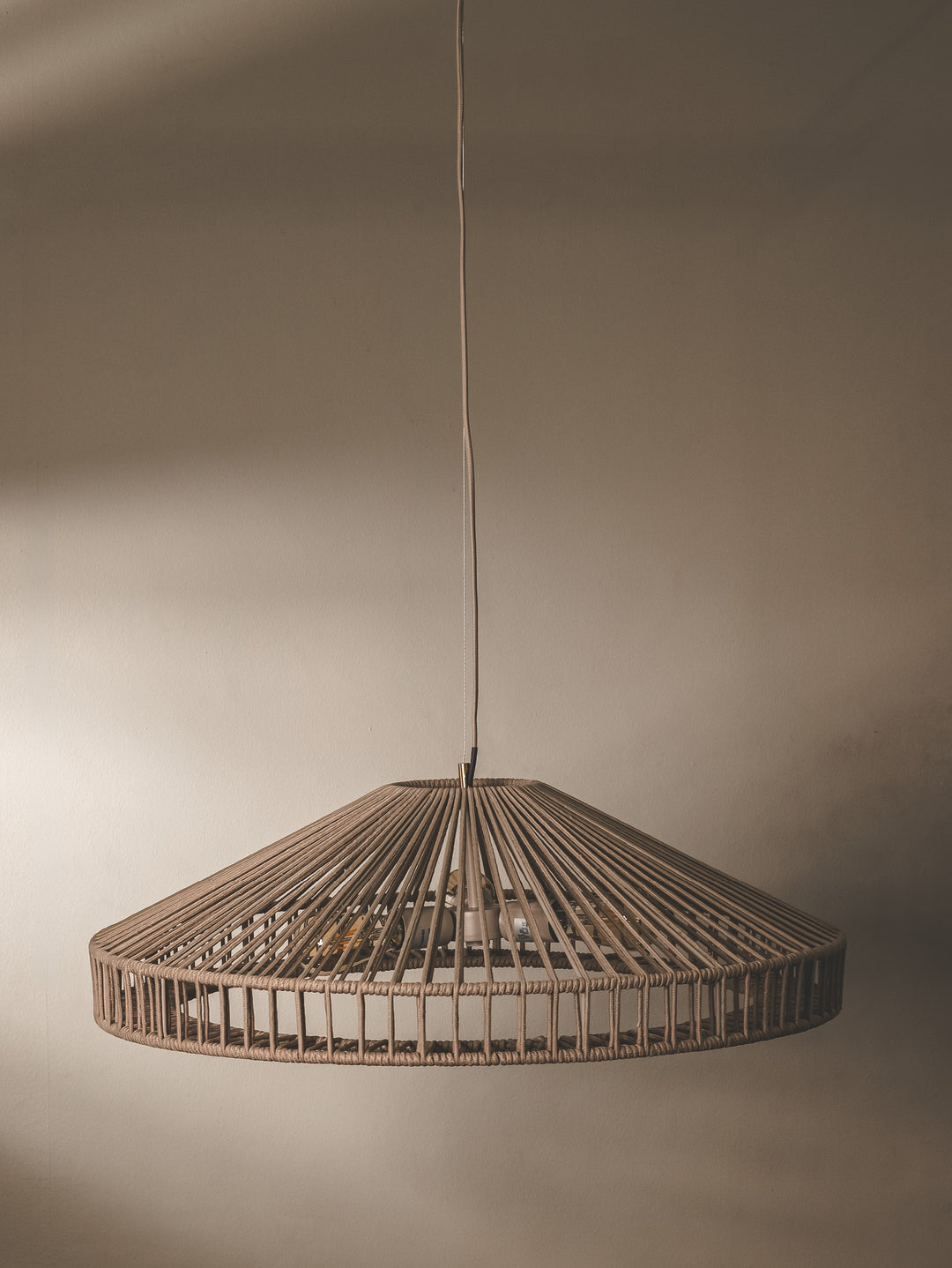 Handwoven undercover patio pendant made with UV-resistant rope in a fossil brown colourway.