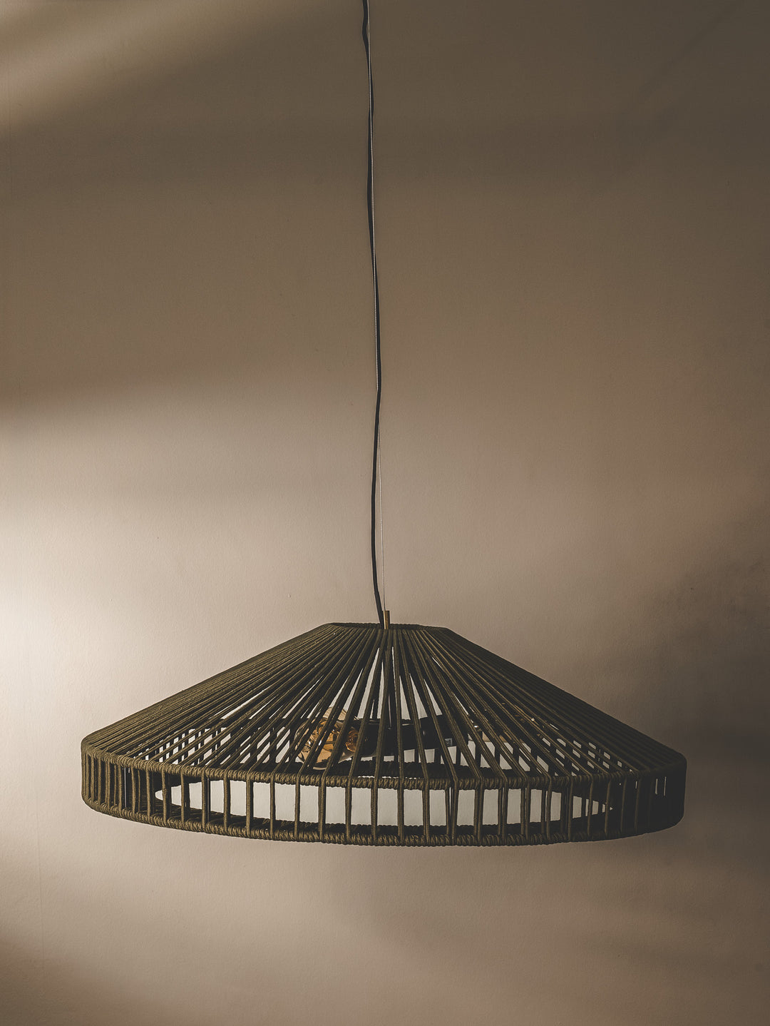 Handwoven undercover patio pendant made with UV-resistant rope in a matcha green colourway.