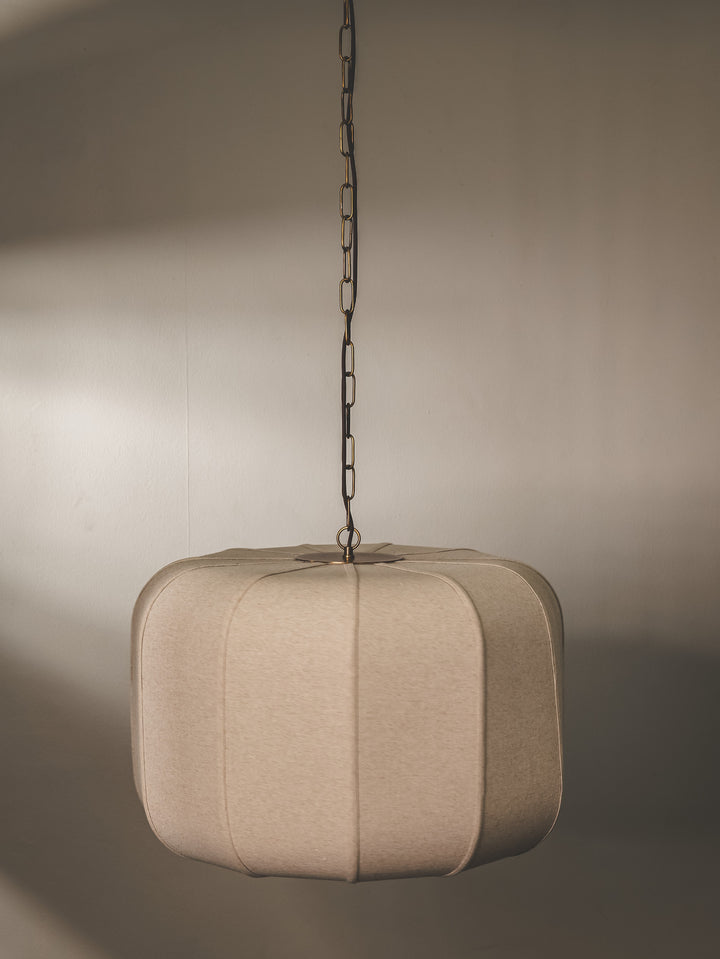 Pendant light with hand-stitched linen lampshade and steel composition.