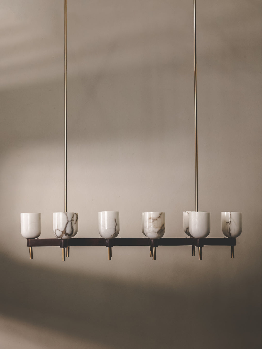 Chandelier composed of mango wood and steel, and features 10 shades made of semi-translucent alabaster.