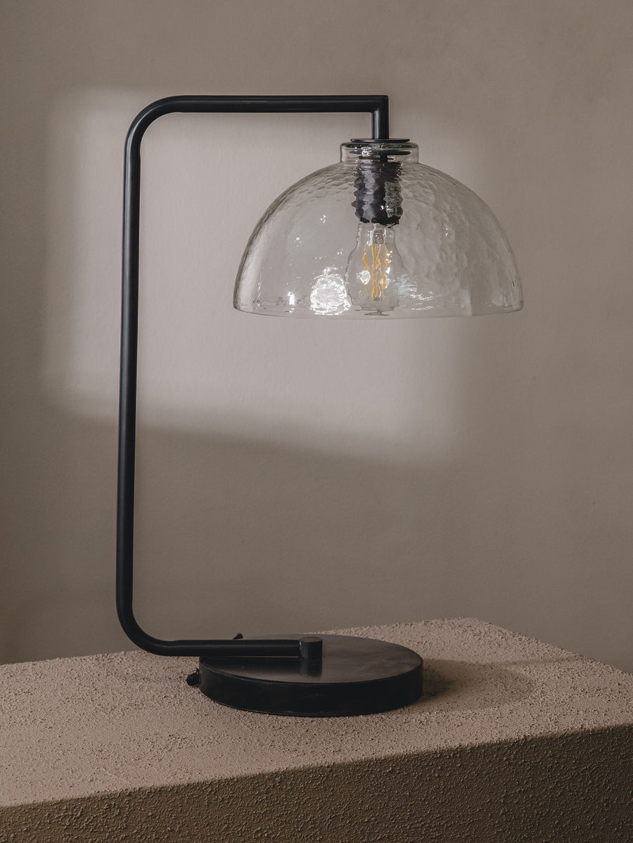 Table lamp with steel frame, glass shade and marble base in a black colourway.