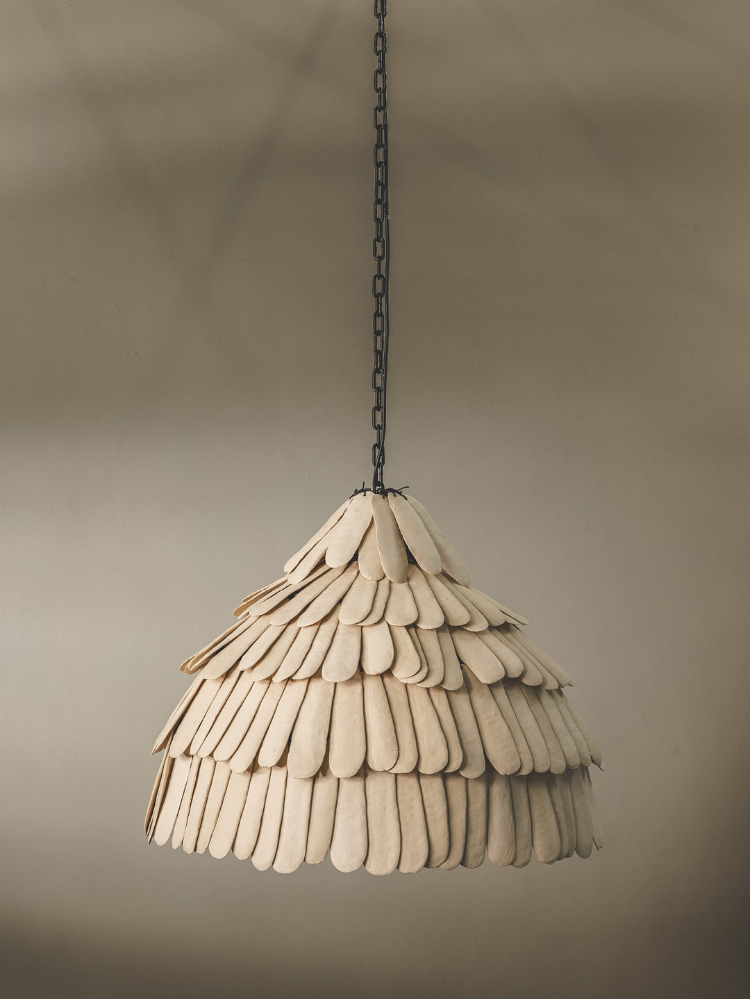 Locally crafted pendant light featuring a handmade ceramic shade in a bone colourway and durable steel support.