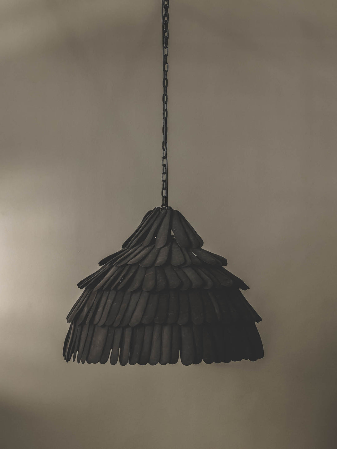 Locally crafted pendant light featuring a handmade ceramic shade in a black colourway and durable steel support.