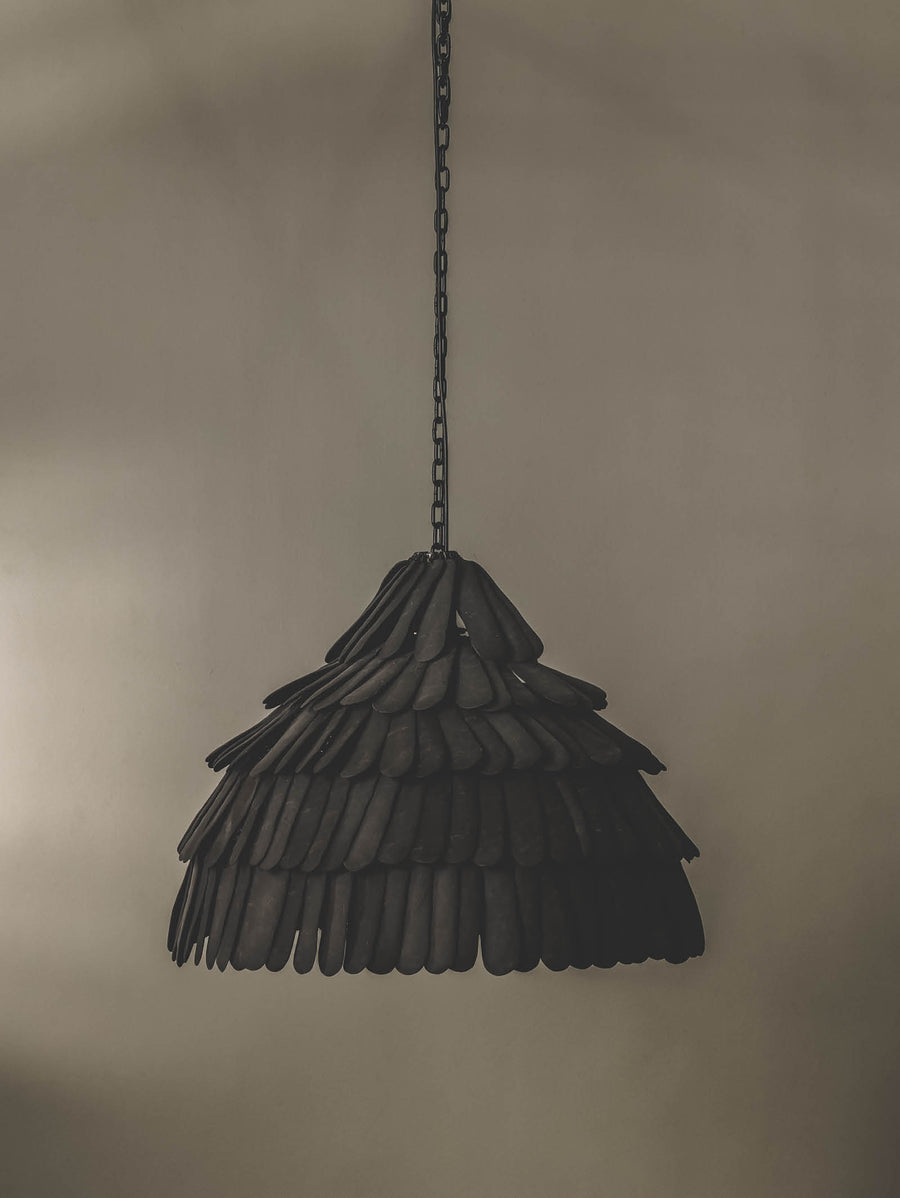 Locally crafted pendant light featuring a handmade ceramic shade in a black colourway and durable steel support.