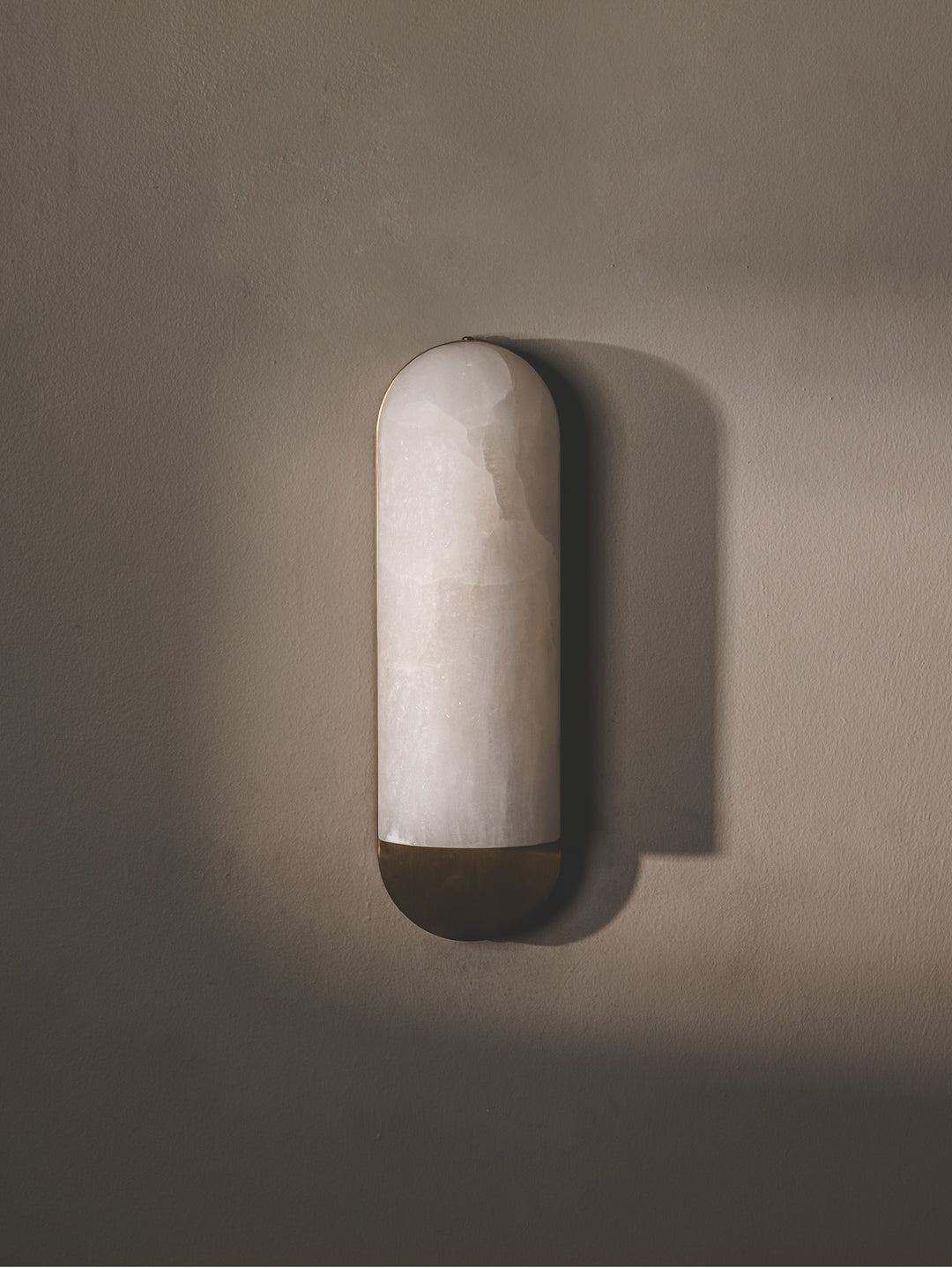 Alabaster marble wall light with polished surface.