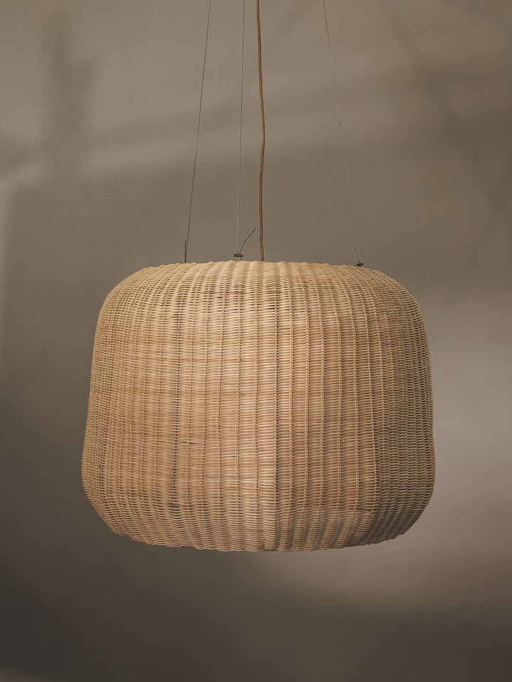 Handmade pendant with shade made of rattan weave encasing frosted glass, with steel support.