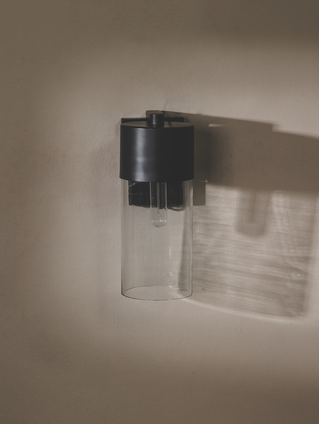 Wall light with steel support, glass shade and marble base.