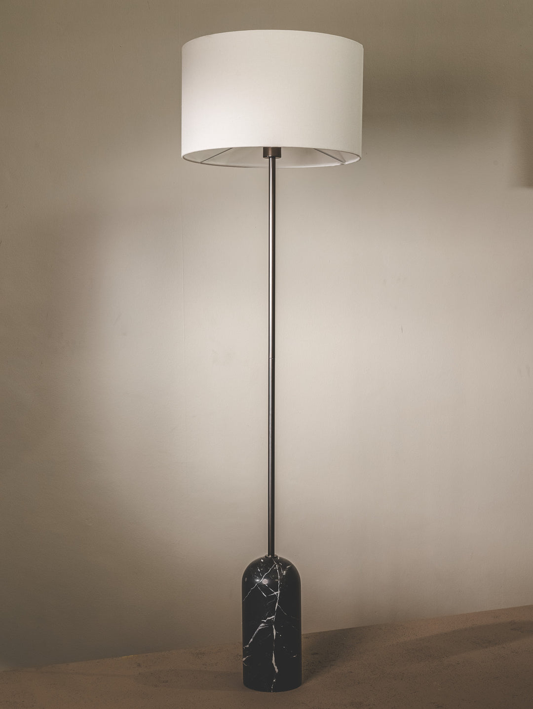 Marble floor lamp with fabric shade and brass fixtures.