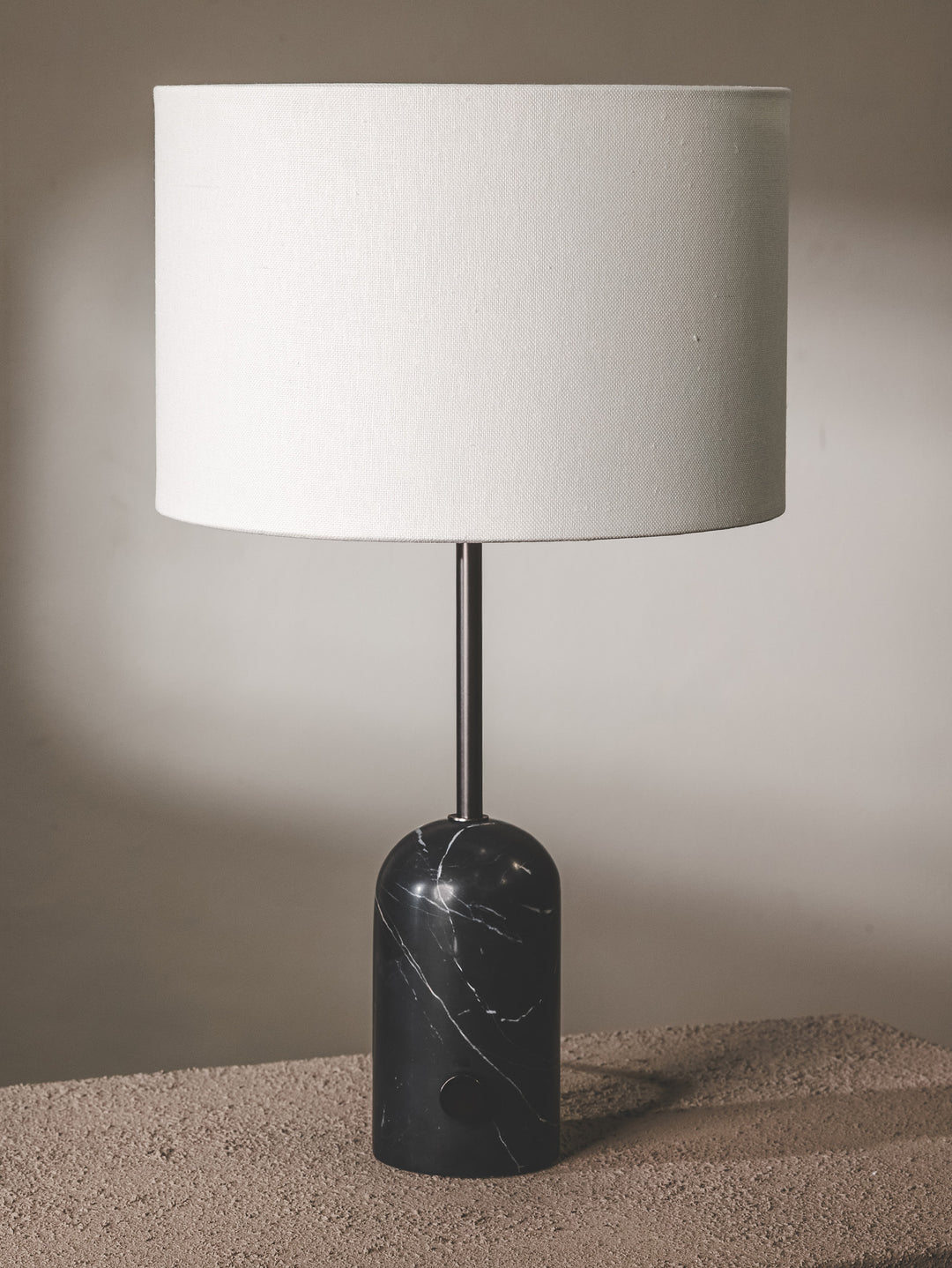 Marble table lamp and fabric shade with brass fixtures.